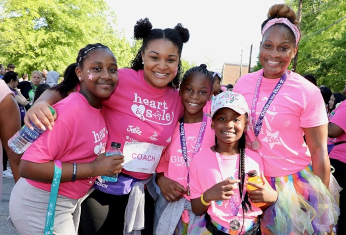 Coach and GOTR and Heart & Sole girls smiling at the camera after the 5K